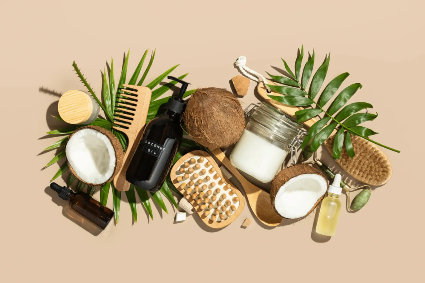 Massage oils, brushes and coconut on a warm background
